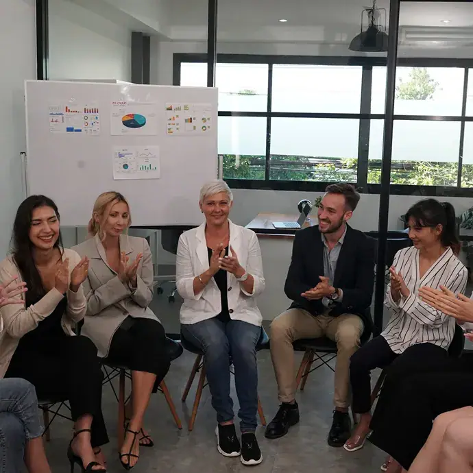 Business owners applaud during a group training session